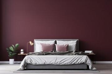 A wide shot of a modern bedroom with a dark bed set against a rich burgundy wall, highlighting an empty mockup frame. Blank empty mockup frame.