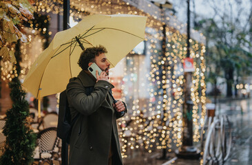 A businessman busy on a phone call outside in the city. He is discussing project details and...