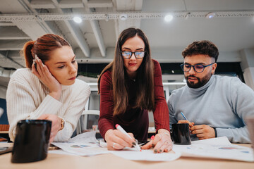 Multicultural business team reviewing statistics in the office.