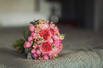 Wedding bouquet of the bride. Beautiful wedding bouquet with different flowers. Bride's and groom's a wedding bouquet, wedding details. A beautiful photo with details of the wedding.