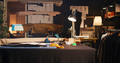 Empty tailor atelier with sewing tools and workstation, workshop used to design custom made clothes...