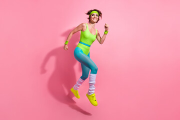 Full length profile portrait of energetic active sporty person jump rush isolated on pink color...