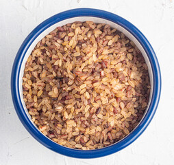 Nigerian locally grown unpolished rice also known as ofada rice. Raw ofada rice