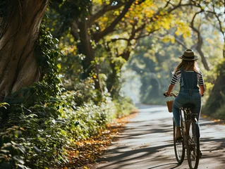 Fotobehang Young woman riding a vintage bicycle. Scenic summer photo. Earthen road in the forest, Concept: girls cycling solitude in nature © Marynkka_muis_ua