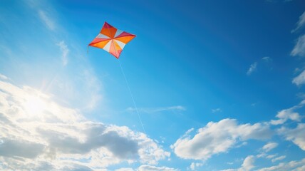 A colorful kite flying high in a bright blue sky - obrazy, fototapety, plakaty