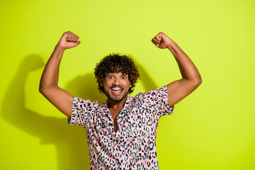 Photo portrait of handsome young guy raise fists celebrate wear trendy pink leopard print outfit...
