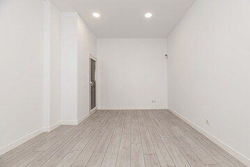 An empty room in an apartment with white walls,