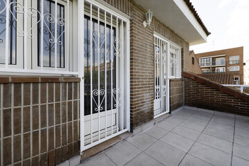 Terrace of a multi-story single-family home with anti-intrusion gates