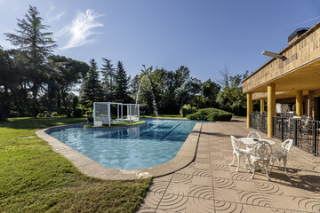 A nice pool with metal Balinese beds