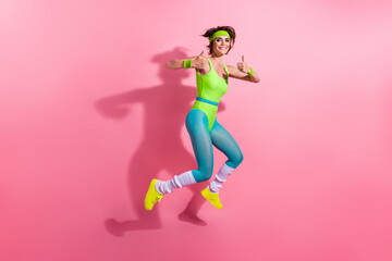 Full body profile portrait of motivated sporty lady jumping demonstrate thumb up approve isolated...