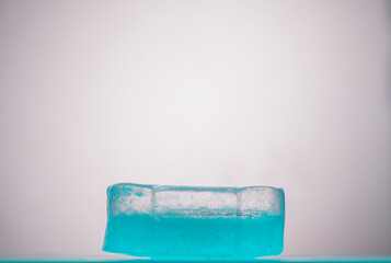 Blue podium with ice. Real ice for presenting the product, background, podium