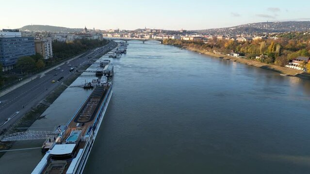 Drone footage of boats moored on the Danube River with Margit Bridge in the background, Hungary