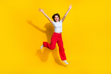 Full length photo of optimistic girl wear t-shirt orange trousers hands up celebrate black friday...
