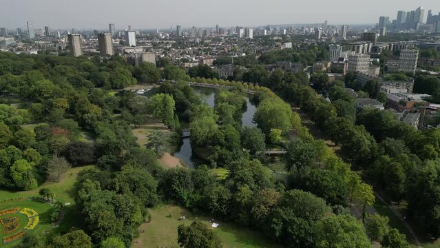 Aerial footage of Victoria Park with skyline of London City in the background, England, UK