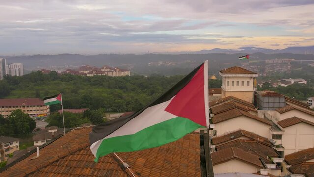 Aerial view of the Palestine National flag waving above the neighborhood in the city