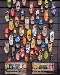 Assemblage of typical Dutch shoes painted with different colors and motifs
