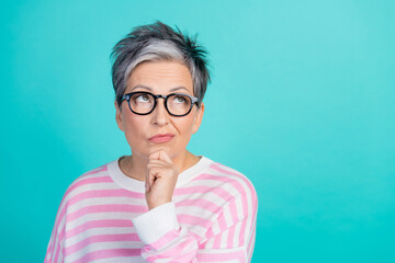 Photo of clever uncertain lady wear striped sweater spectacles arm hand chin looking empty space...
