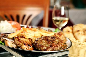 Bbq meat with rice, potato and vegetables
