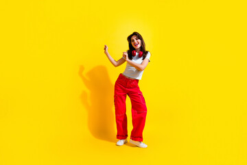Fototapeta na wymiar Full length photo of cute pretty woman dressed white t-shirt headphones having fun discotheque empty space isolated yellow color background