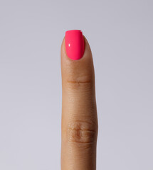 finger with pink manicure 