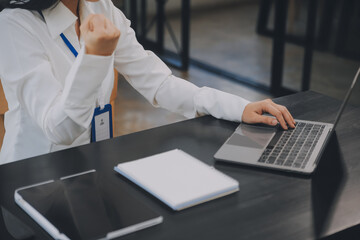 Entrepreneur Asian businessman and businesswoman discussing new business project in tablet in modern Meeting In Modern Office, Asian business casual concept.