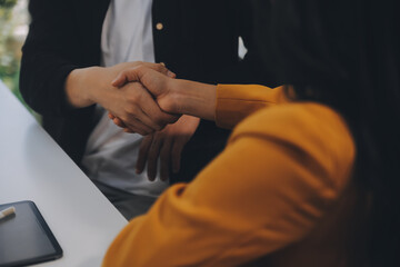 Fototapeta premium Charming Young asian businesswoman sitting on laptop computer in the office, making report calculating balance Internal Revenue Service checking document.