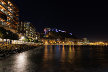 Fototapeta na wymiar View of the illuminated Alicante from the sea at night.