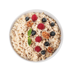 Tasty boiled oatmeal with berries and walnuts in bowl isolated on white, top view