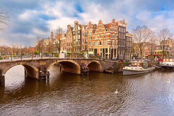 Obraz premium Amsterdam canal with bridge and typical houses, Holland, Netherlands.