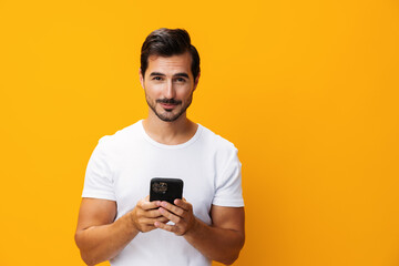 Phone man happy studio phone communication technology portrait yellow cyberspace space copy mobile smartphone smiling