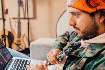 Musician using computer in a home music studio