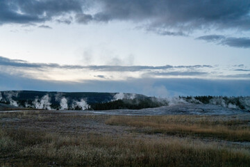 Grand Old Faithful geyser sunset eruption explosion steam Yellowstone National Park observation deck Upper Geyser Basin fall autumn beautiful