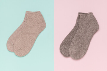 Two pairs of warm socks on a two-tone background.