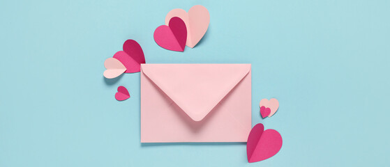 Envelope and paper hearts on light blue background, top view. Valentine's Day celebration