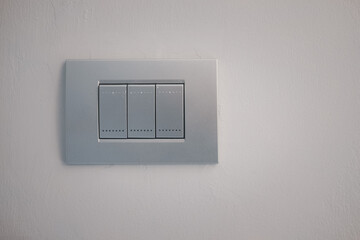 Electric light switch panel silver color, turning on or off on light switch. Copy space.