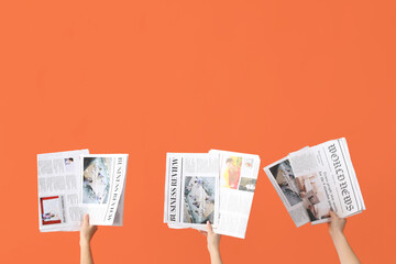 Women with newspapers on orange background