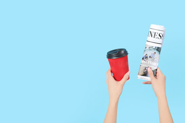 Woman with rolled newspaper and coffee cup on blue background - obrazy, fototapety, plakaty