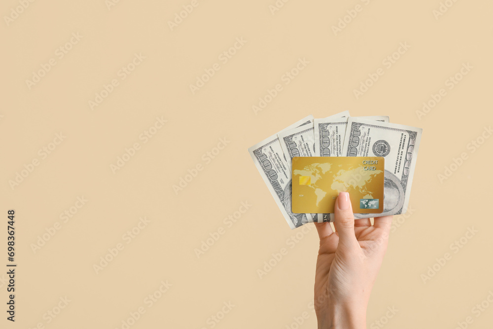 Canvas Prints Woman with credit card and dollar banknotes on beige background