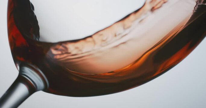 red wine flowing into the bottom of a glass, closeup, highspeed