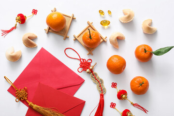Composition with red envelopes, fortune cookies, tangerines and Chinese symbols on white...