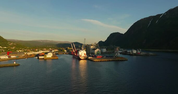 Commercial port and Helgeland Industrial Park, Northern Norway. Aerial during Midnight Sun