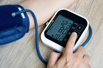 Man check blood pressure monitor and heart rate monitor with digital pressure gauge. Health care...