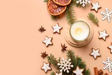 Star-shaped gingerbread cookies with fir branches and burning candle on brown background