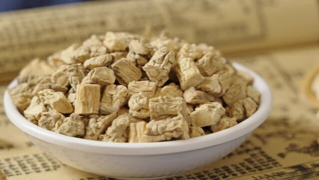 Chinese herb medicine codonopsis root on old book.