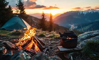 Fotobehang A camping scene with a pot on a stove and a view of the sunset © Bipul Kumar