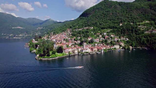 Static aerial landscape of boat cruising past Torno, Lake Como, Italy