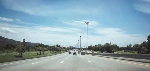 Traveling on motorway. Driving to another province. Road Trip in Thailand on sunny day.