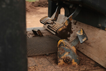 Close up photo of old rusted metal yellow tractor bulldozer.
