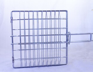 A metal grid used for outdoor cooking in South Africa isolated on a clear background with copy space