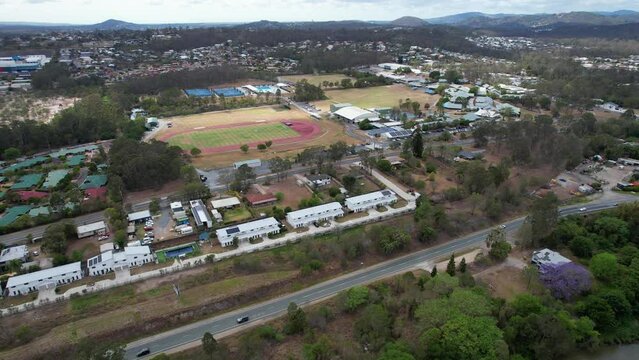 Swim School, Football Field, And Townhomes In Waterford, Queensland, Australia. aerial pullback shot